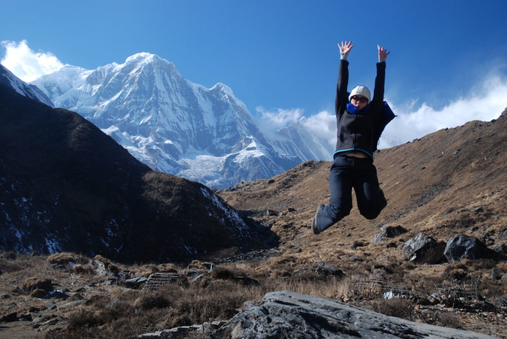 Jumping for joy in front of Annapurna South, Nepal.