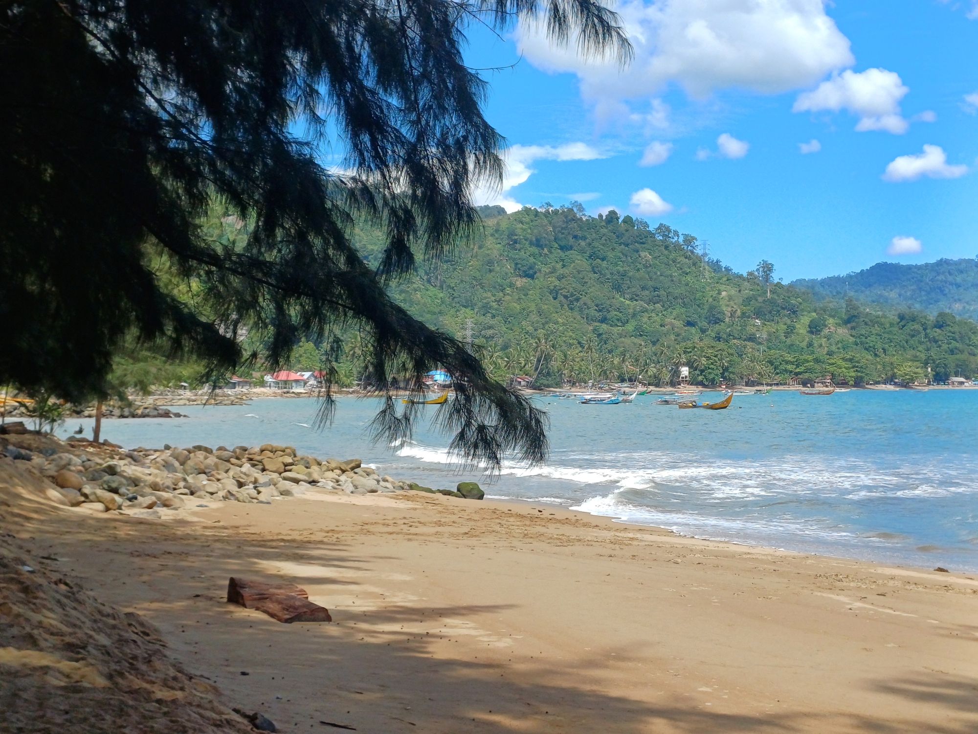 Local fishing boats in the bay, Pantai Carolina